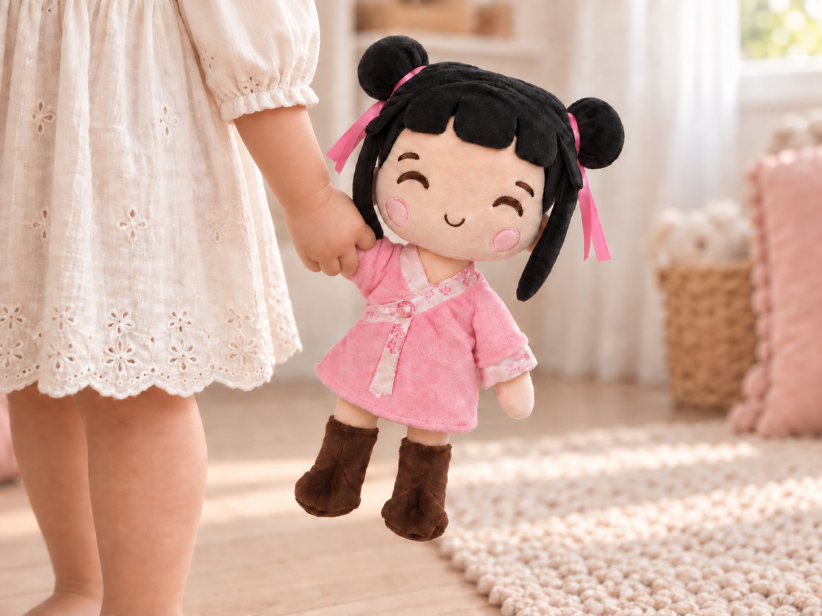 A child holding Nini gently by one hand