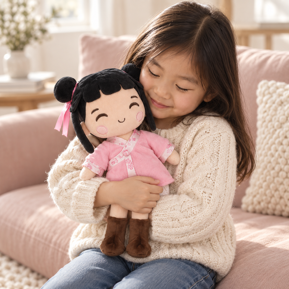 A girl cuddling Nini, with her upper body and the full doll visible
